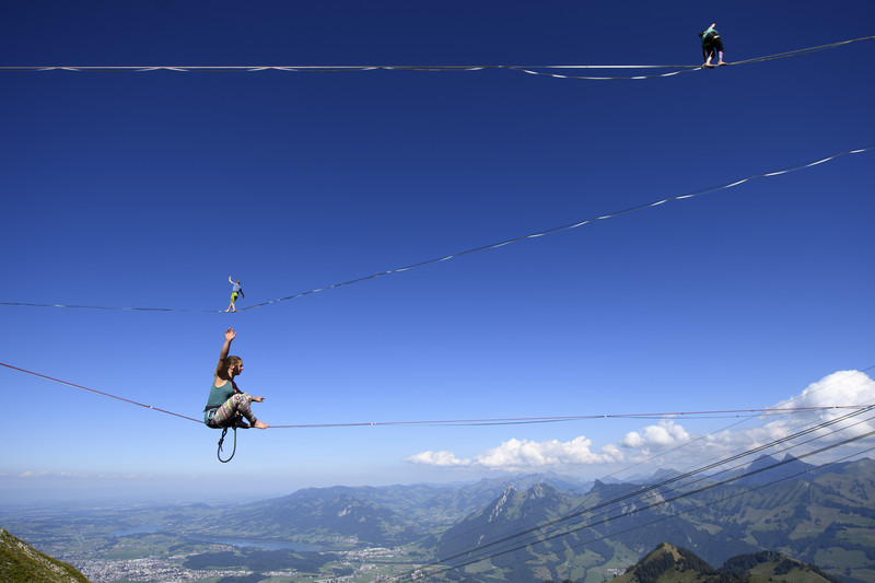 epaselect epa05530333 Professional mountaineers walk on parallel lines during the Highline Extreme event on the top of the Moleson peak at 2000 meters above the sea level, in the Swiss Alps, near Fribourg, Switzerland, 08 September 2016. Twenty-five of the European best slackliners compete until 11 September, on eight different lines ranging from 45 metres to 495 metres. Balancing on the 'slackline' is a training method for climbers to improve their equilibrium sense. To avoid the danger of falling down, the athletes are secured with a rope.  EPA/LAURENT GILLIERON